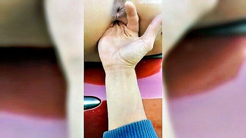 Blonde woman exposes ass in car, hand fingering anus closeup