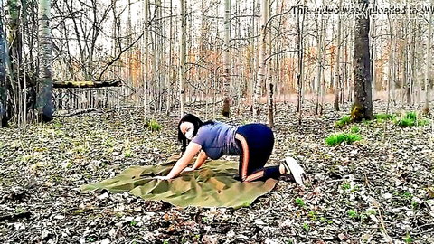 Brunette in doggy pose outdoors with corona mask, tank top and leggings