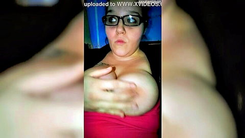 Curvy brunette with glasses exposing large breasts in amateur solo