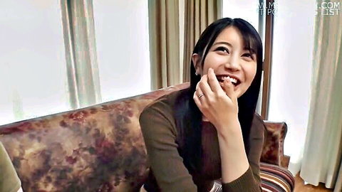 Smiling Japanese wife in brown sweater, hand to mouth