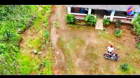 Aerial shot of man on red motorcycle outside rural Indian home, DevDasi Hindi web series thumbnail