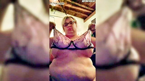 Chubby blonde BBW lifts pink bra to show soft huge tits