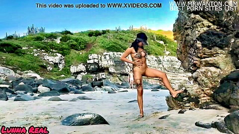 Nude ebony woman posing seductively on beach with Victor Hugo