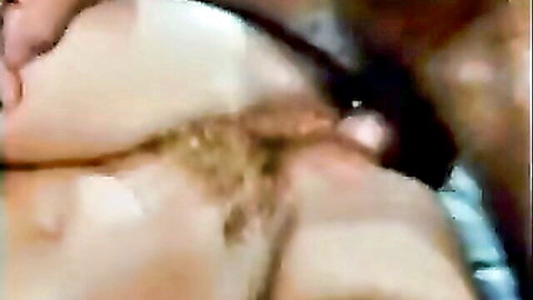 Closeup of pale hairy asshole stretched wide around black jeweled butt plug