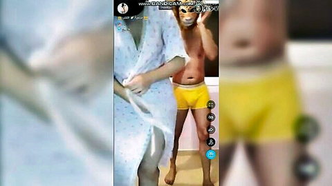 Arab MILF in open white robe grabs boyfriend's cock bulge in yellow shorts webcam tease