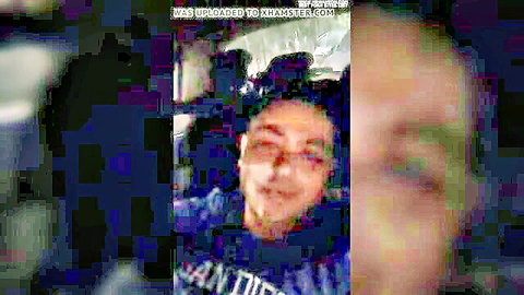 Blurry smiling man in sunglasses smiling in car interior amateur video