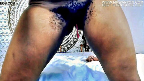 Black girl spreads legs to show wet pussy and bushy pubes in thong