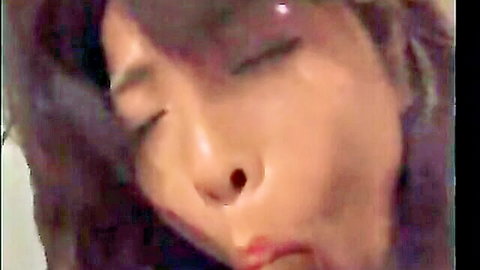 Close-up of aroused Asian woman with half-closed eyes and open mouth