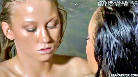 Wet topless blonde and brunette lesbians kissing intimately with shiny tits in pool
