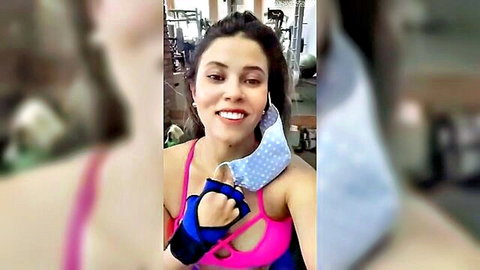 Fit Latina gym babe in revealing pink sports bra smiling selfie with mask