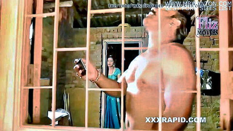 Indian bhabhi in blue saree peeked at by muscular neighbor holding phone