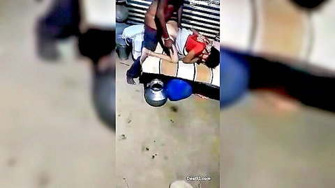 Indian man stands fucking busty woman's exposed tits and pussy outdoors on blue mat