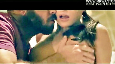 Bearded man passionately embraces and kisses topless Asian woman