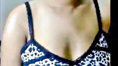 Sexy woman in leopard print bra showing deep cleavage