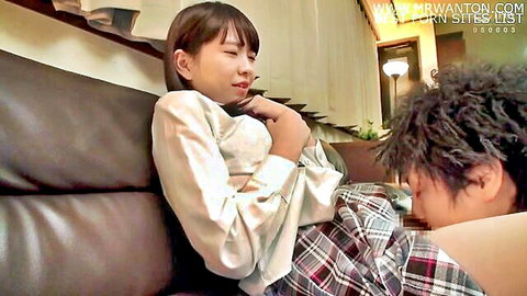 Japanese schoolgirl in uniform receives oral from guy on couch