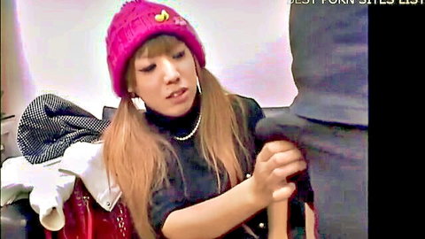 Cute Asian girl in pink beanie and pigtails gives clothed handjob
