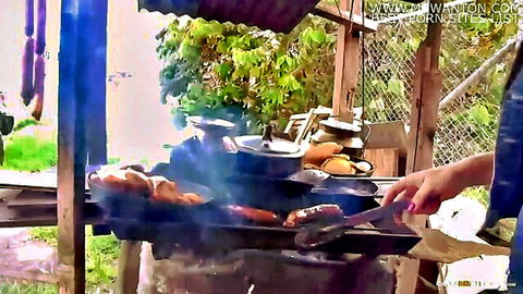 Lola Puentes Latina brunette grilling sausages in steamy outdoor cookout