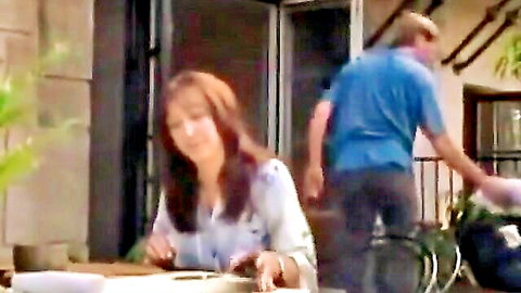 Lauren Hays in casual outdoor patio scene with man, teasing vibes