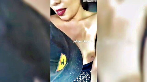 Latina woman exposing breast in low-cut black top selfie