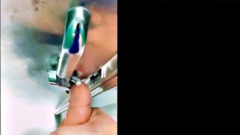 Close-up of hand turning green shower faucet in amateur solo cumshot clip