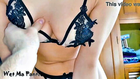 Man's hand gropes and pulls down busty teen's black lace bra exposing pink nipple