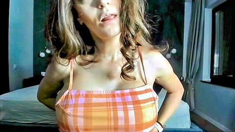 Curvy brunette with pregnancy boobs in low-cut plaid tank top
