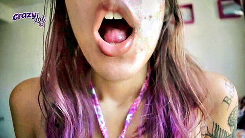 Purple-haired girl moans with long tongue out, close-up tease