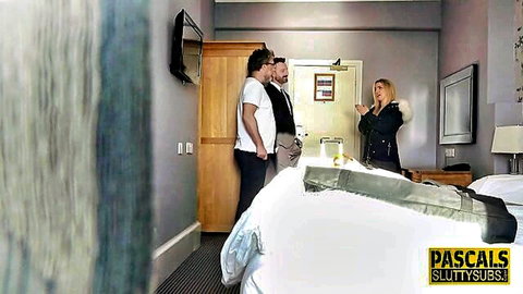 Blonde in fur coat greets two suited men in hotel bedroom for rough sex