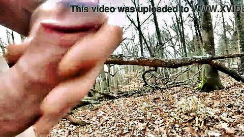Fingers spreading wide open wet pink pussy lips in outdoor forest closeup