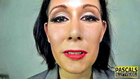 Mature brunette with glossy red lips and heavy makeup smirks seductively close-up