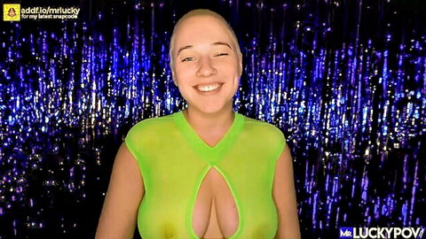 Bald young woman smiles with huge tits exposed through sheer green top