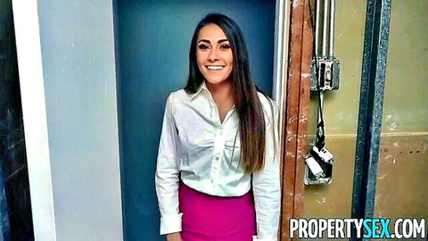 Mackenzie Mace as hot young real estate agent smiling in white blouse and pink skirt