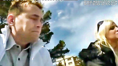 Blonde couple outdoors in vacation setting, wife swap special