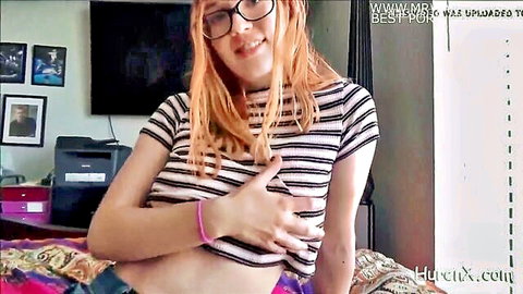 Hot redhead in glasses and striped crop top showing cleavage