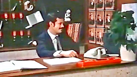 Vintage suited hotel clerk with mustache at reception desk, Nympho Nuns thumbnail