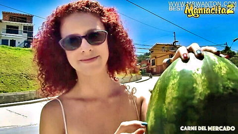 Colombian redhead Elisa Odiosa smiling with watermelon outdoors