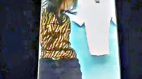 Asian woman in tiger print top showing cleavage, seductive back view in JAV