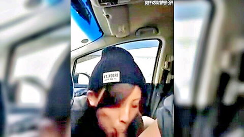 Eager Asian woman in beanie teases with open mouth in car ride home