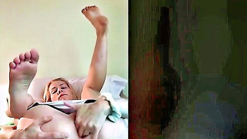 Blonde woman quietly masturbating on bed, hand between legs, sneaky solo play