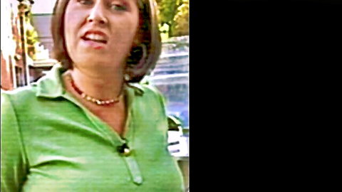 Mature brunette MILF in green shirt showing deep big tits cleavage