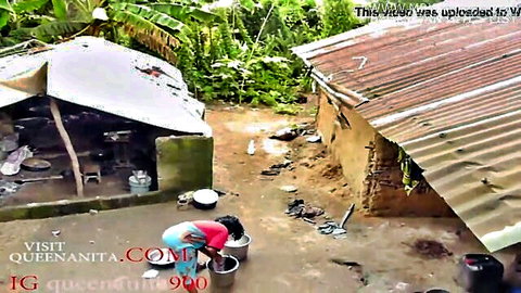 Rural black woman squatting outdoors pouring water in amateur video thumbnail