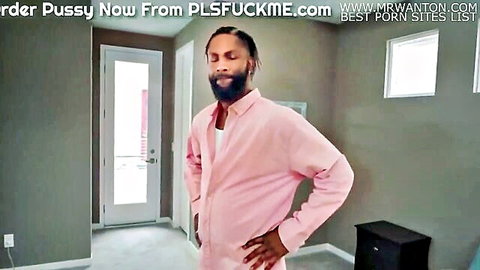Black man in pink shirt posing in room, porn site ad overlay
