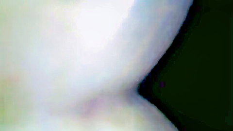 Blurry solo woman in sheer white top revealing curves