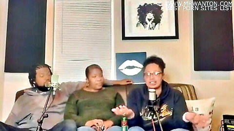 Black woman and two guys in hoodies chatting on couch during porn podcast with mics and chips