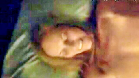 Blonde MILF smiling seductively in bed on green pillow morning tease
