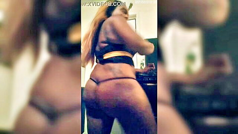 Thick ebony woman with long blonde hair shakes big ass in g-string thong