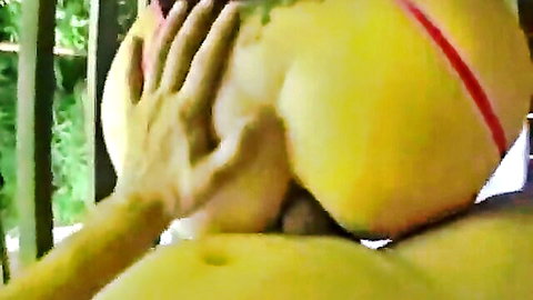 Close-up of deep anal penetration in curvy woman's big yellow-clad butt
