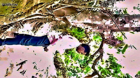 Desi girl lying outdoors in jeans and white top, natural setting