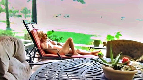 Blonde mature granny lounging topless outdoors by pool