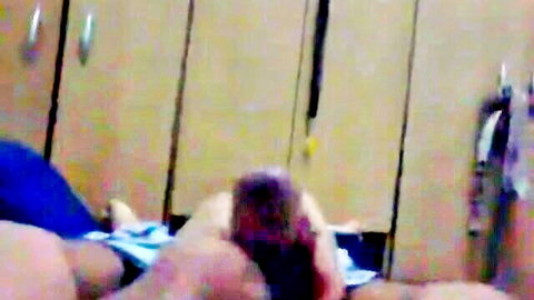 Amateur POV closeup of hard cock head gripped by hand with jeans pulled down near wooden wardrobe.